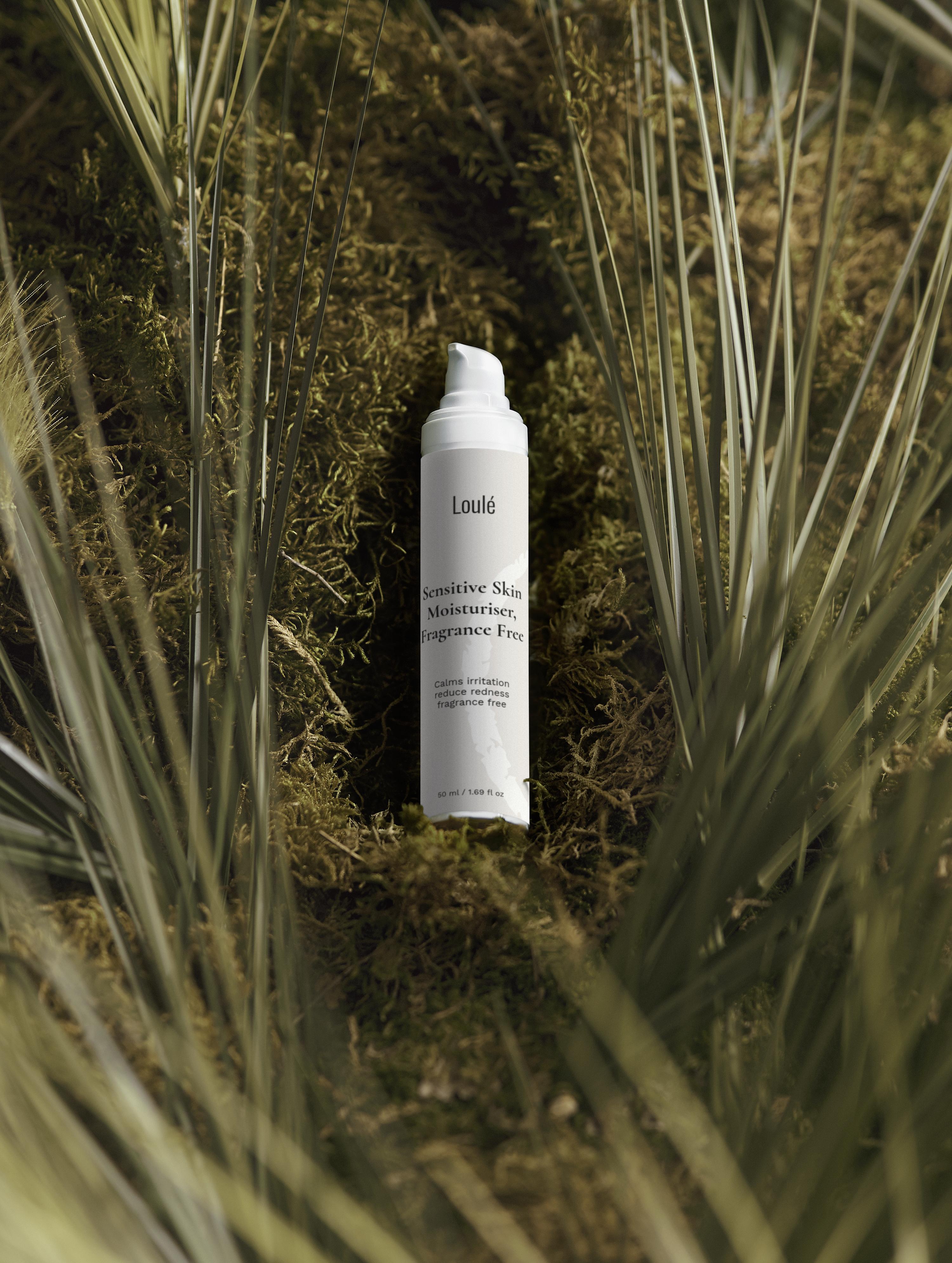 Sensitive Skin Moisturiser, Fragrance Free by Loulé placed on natural moss with palm leaves, ideal for calming irritation and hydrating sensitive skin.