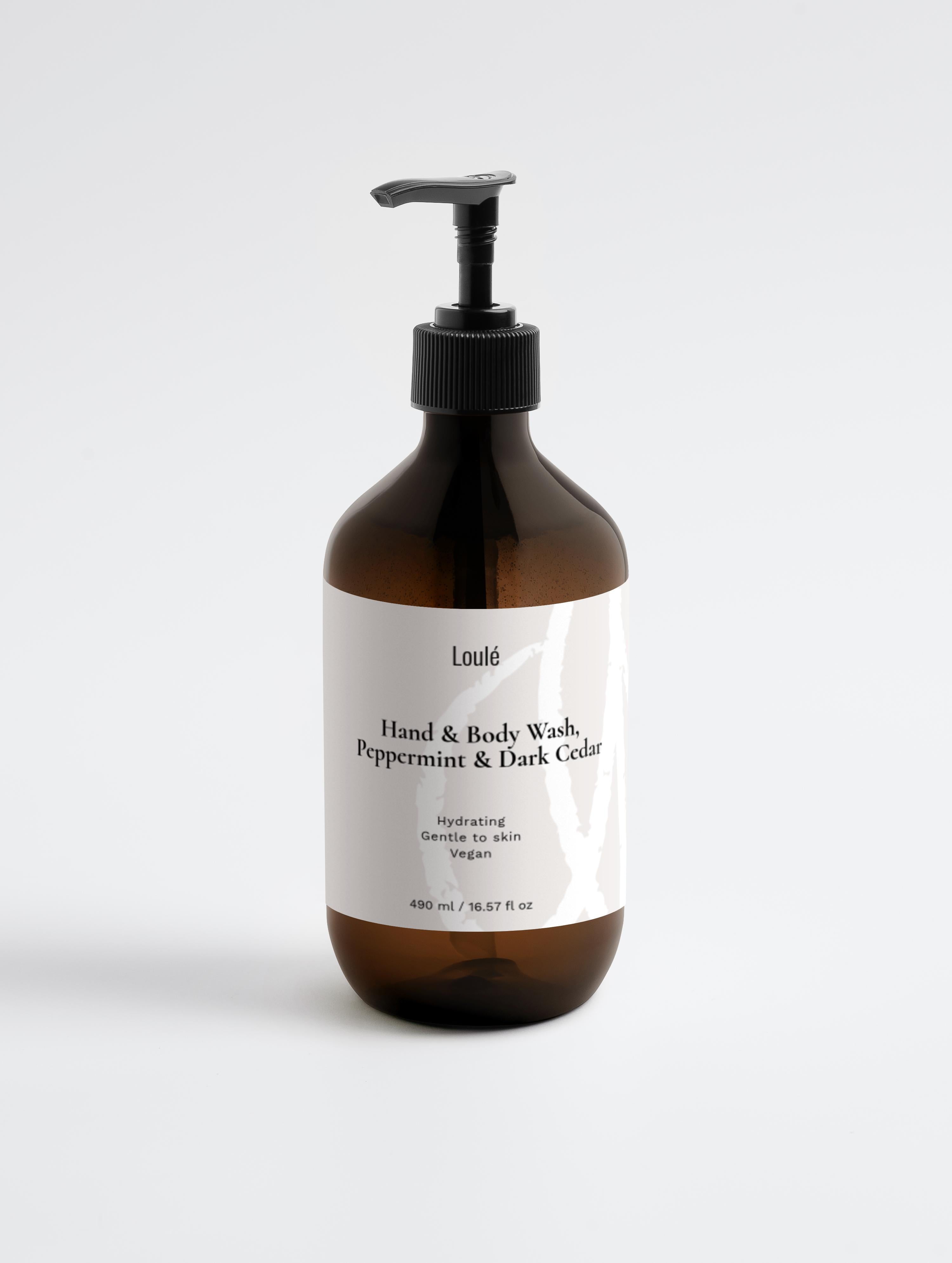 Loulé Skin Hand & Body Wash, Peppermint & Dark Cedar in amber pump bottle. Hydrating vegan formula for gentle cleansing and refreshing skincare.