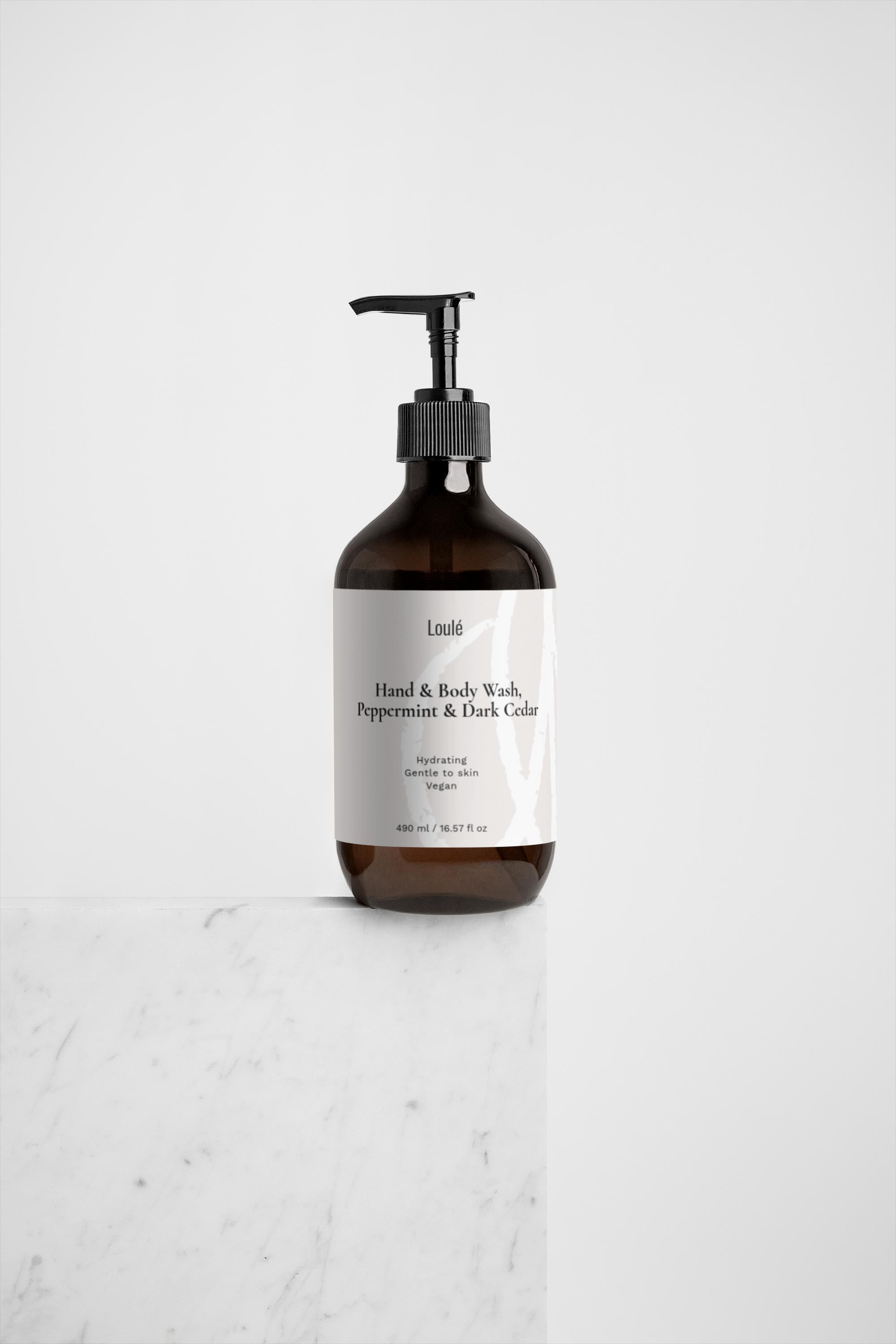 Loulé Skin Hand & Body Wash, Peppermint & Dark Cedar in amber bottle with pump, ideal for hydrating and refreshing skincare routines.